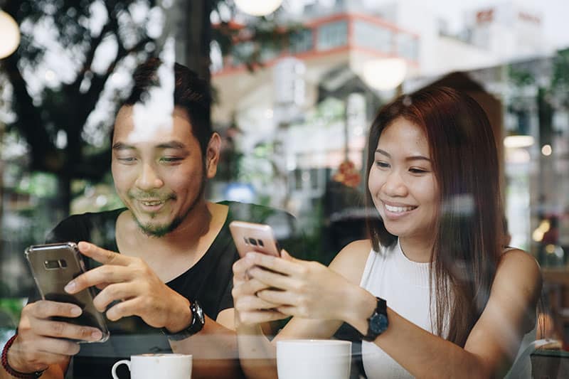 mobile users interacting with paid social media advertising